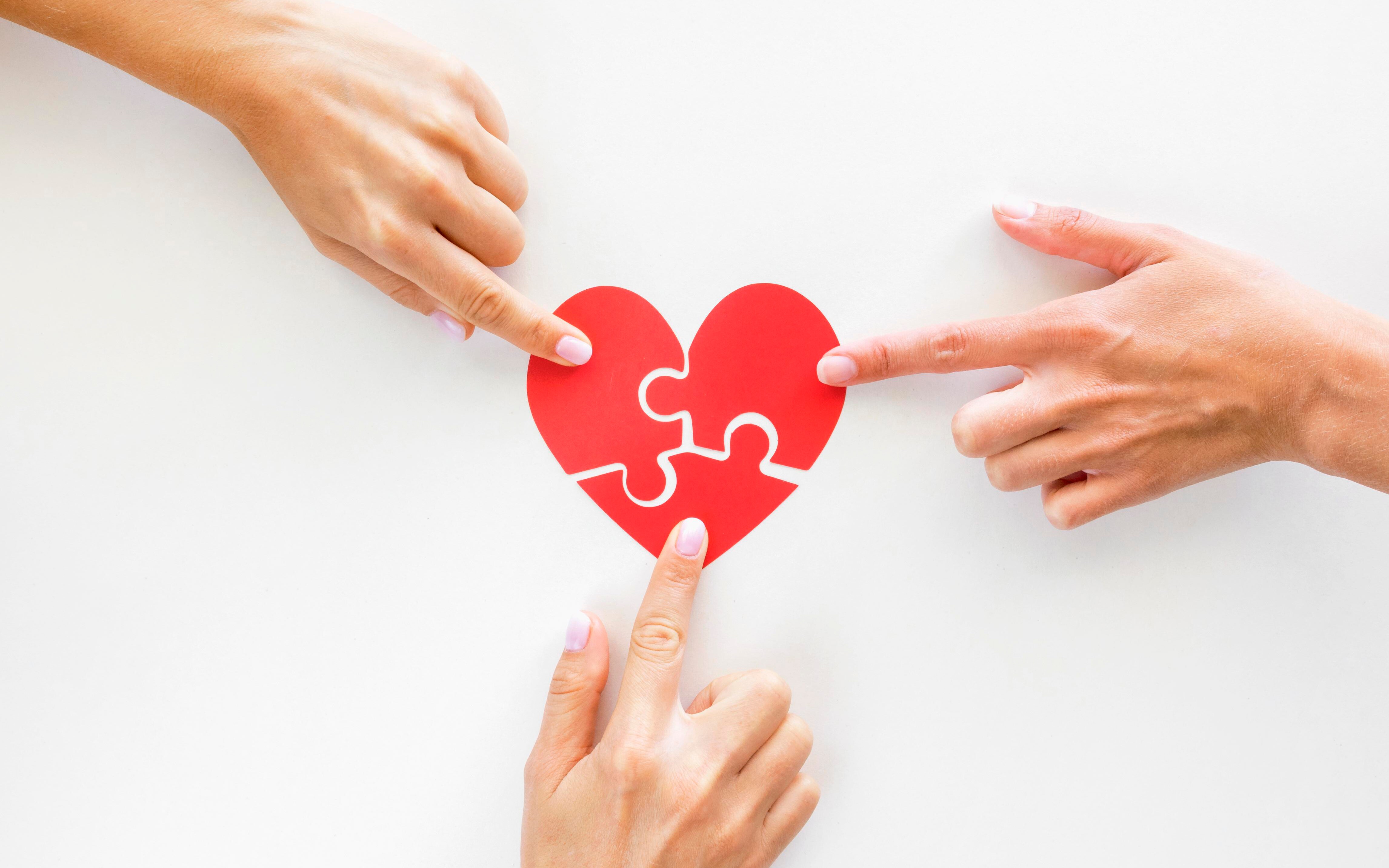 Fingers touching a heart